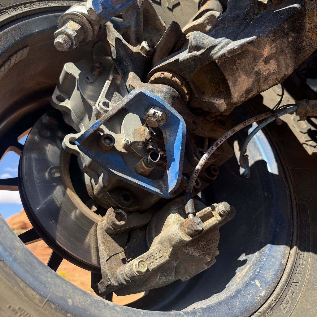 Close up lower view of Portal Pros portal axle installed on the front right corner of a Jeep Wrangler JK