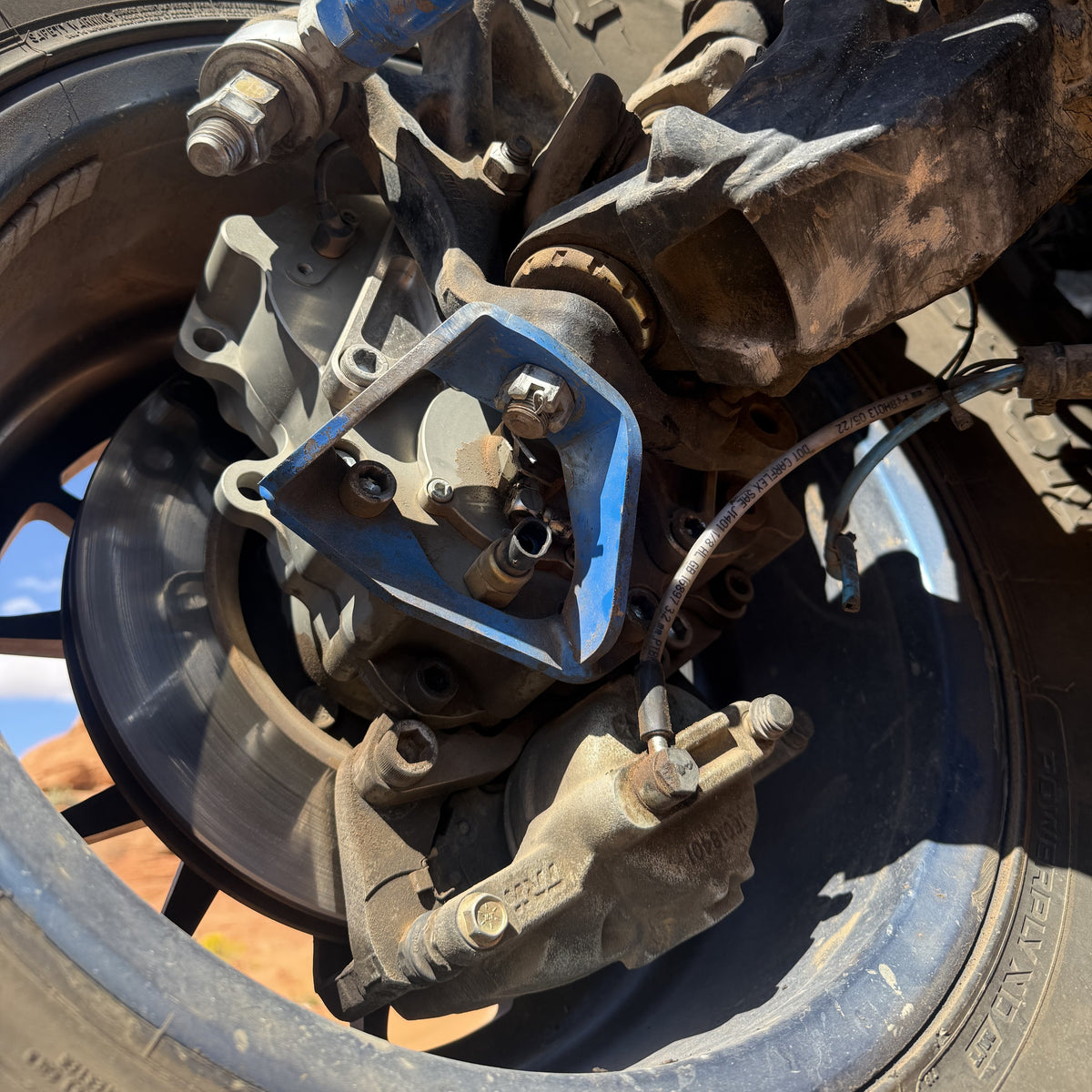 Close up lower view of Portal Pros portal axle installed on the front right corner of a Jeep Wrangler JK
